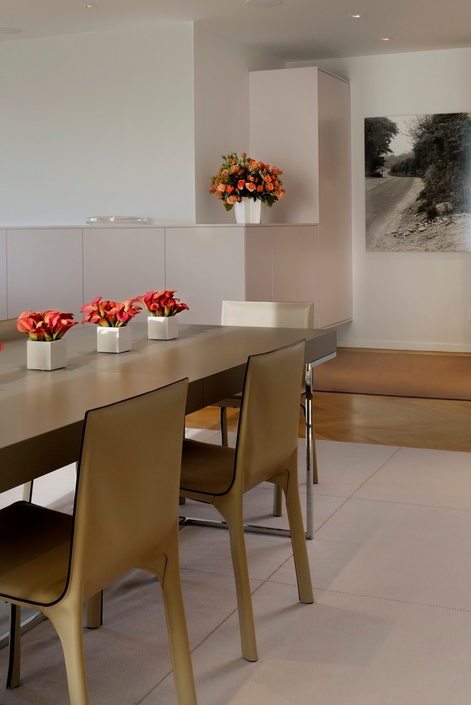 This is an example of a large contemporary open plan dining in San Francisco with white walls and no fireplace.