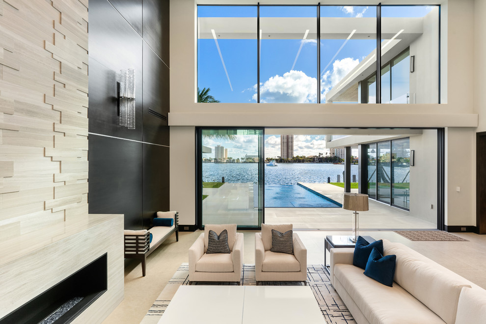 Contemporary open concept living room in Miami with white walls, a ribbon fireplace and beige floor.