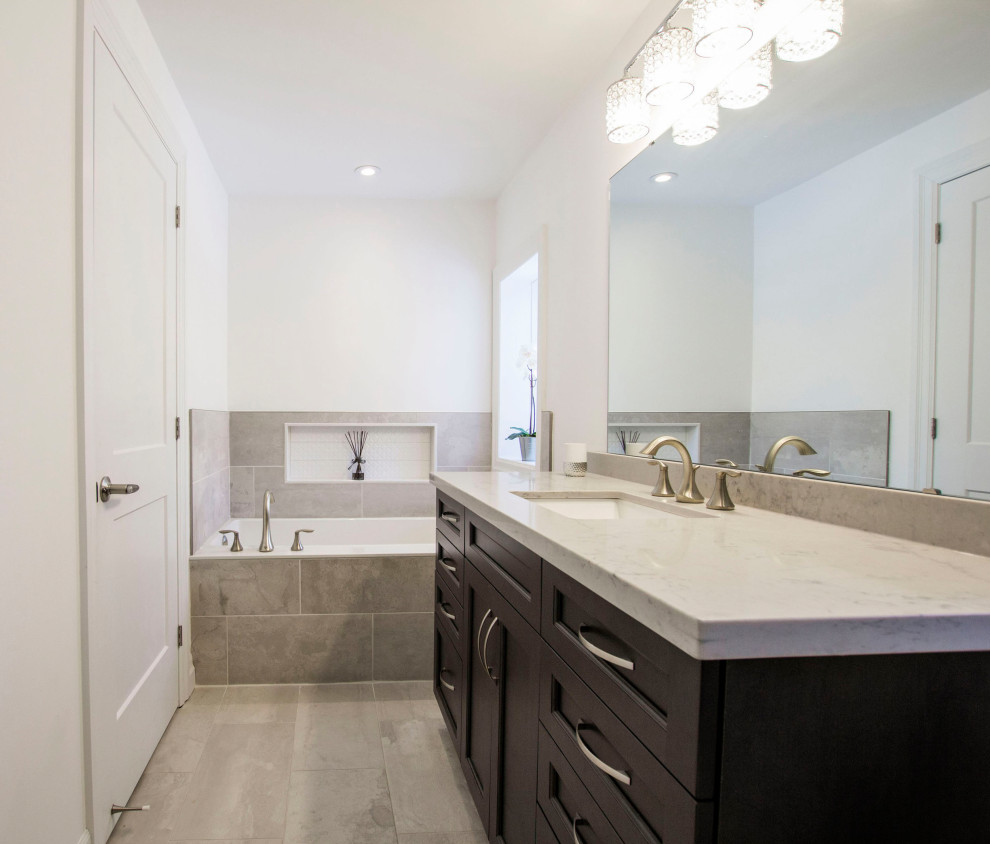 Example of a transitional ceramic tile bathroom design with beaded inset cabinets, quartz countertops and white countertops