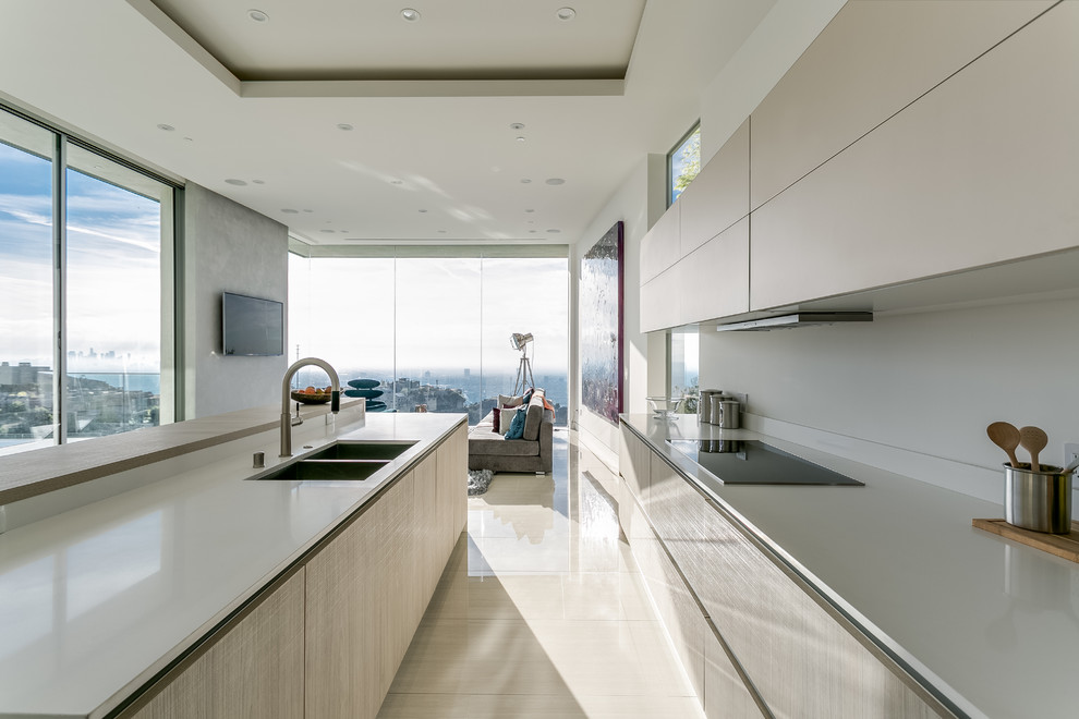 Photo of a mid-sized modern l-shaped open plan kitchen in Los Angeles with a double-bowl sink, flat-panel cabinets, beige cabinets, quartz benchtops, white splashback, stainless steel appliances, ceramic floors and with island.