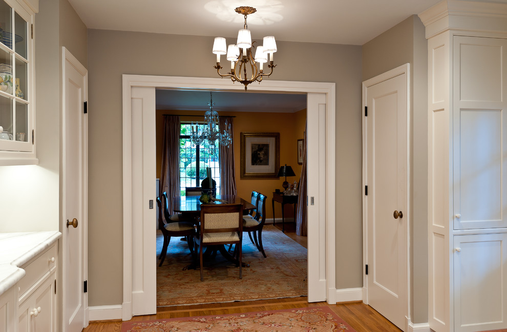 Photo of a small traditional hallway in DC Metro with grey walls, light hardwood floors and beige floor.