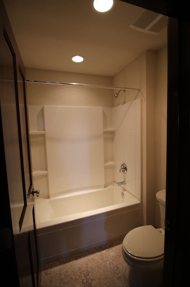 Alcove bathtub - large transitional kids' beige tile and porcelain tile ceramic tile alcove bathtub idea with a drop-in sink, flat-panel cabinets, medium tone wood cabinets, laminate countertops, a two-piece toilet and beige walls
