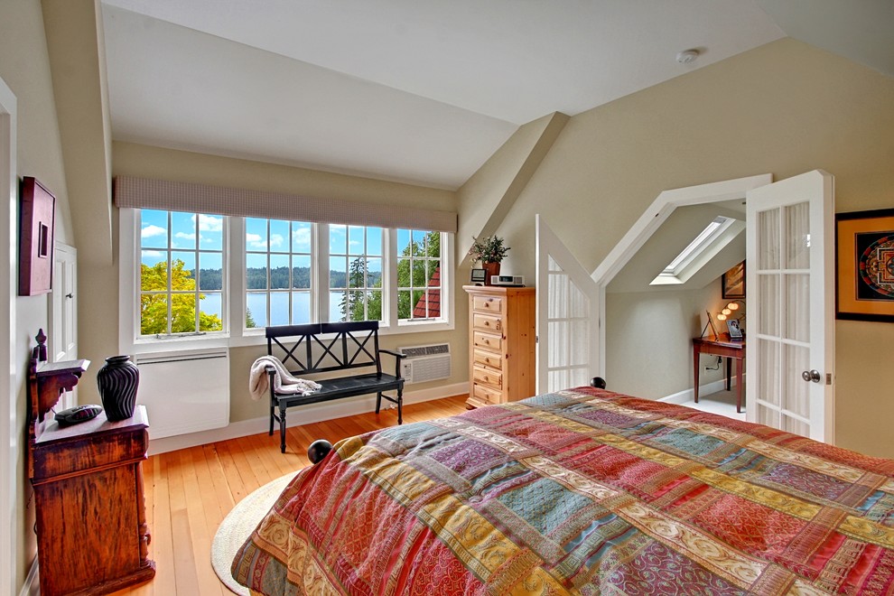 This is an example of a mid-sized country bedroom in Seattle with medium hardwood floors and beige walls.
