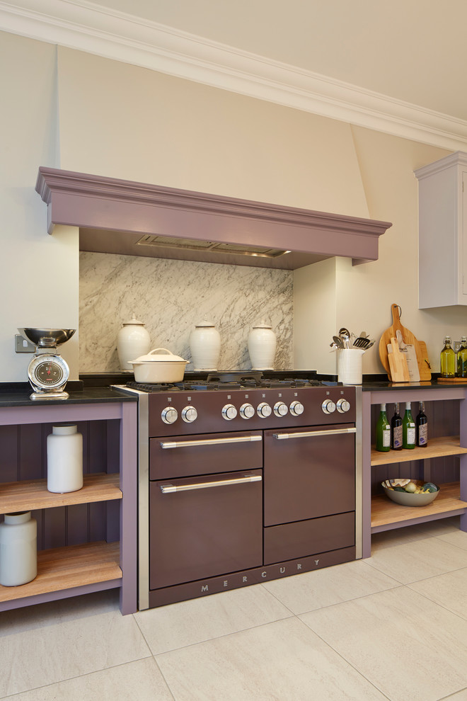 Photo of an expansive contemporary l-shaped eat-in kitchen in Wiltshire with raised-panel cabinets, granite benchtops, grey splashback, coloured appliances, porcelain floors and with island.