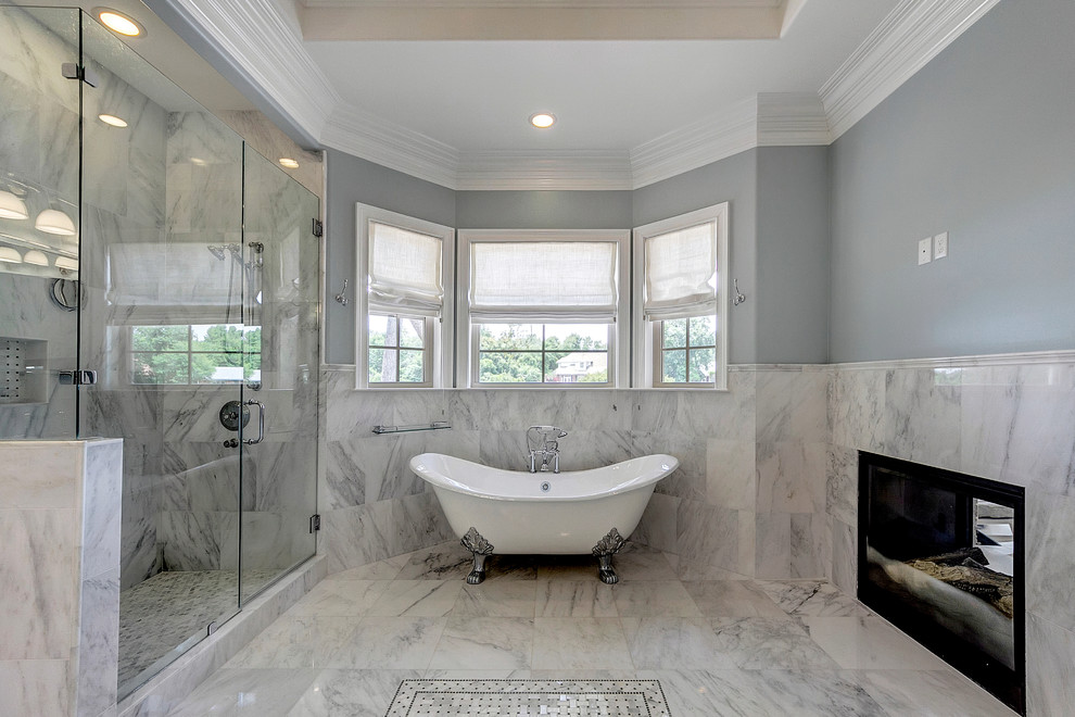 Photo of a traditional bathroom in Miami with a claw-foot tub, a corner shower, white tile and grey walls.