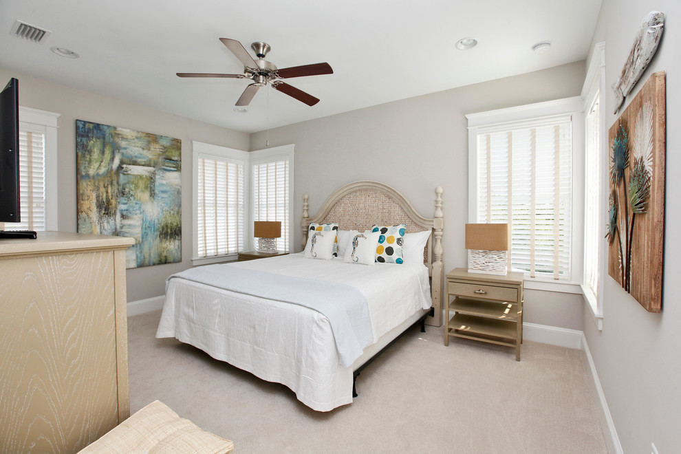 Mid-sized beach style guest bedroom in San Diego with beige walls, carpet and beige floor.