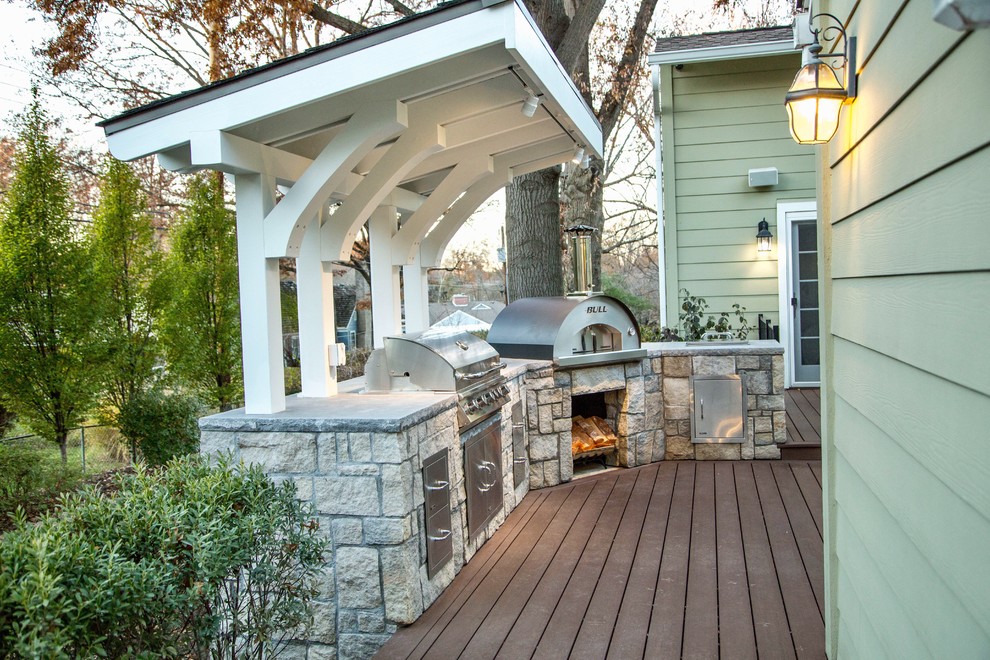 Mid-sized traditional backyard deck in Kansas City with a pergola.