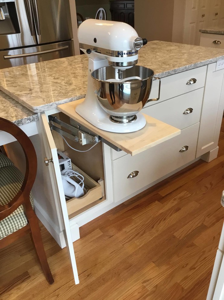 This is an example of a mid-sized transitional l-shaped kitchen in Other with an undermount sink, shaker cabinets, white cabinets, granite benchtops, brown splashback, stainless steel appliances, medium hardwood floors, with island and brown floor.