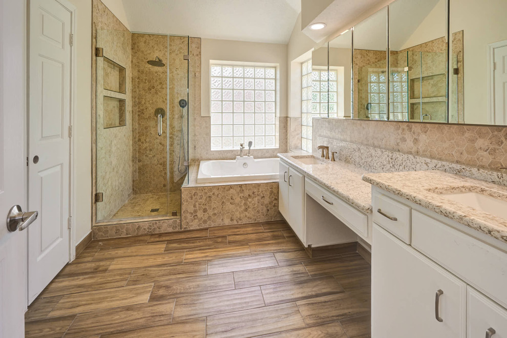 Inspiration for a large modern ensuite bathroom in Houston with flat-panel cabinets, white cabinets, a built-in bath, a corner shower, a two-piece toilet, brown tiles, marble tiles, white walls, cement flooring, a submerged sink, granite worktops, brown floors, a hinged door, beige worktops, a wall niche, double sinks and a built in vanity unit.