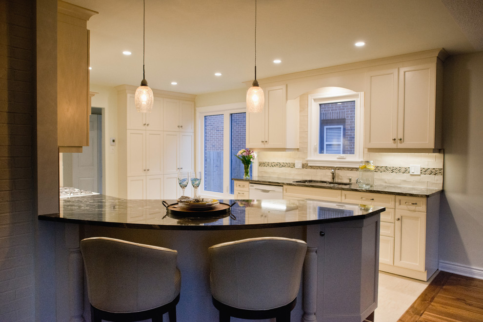 Inspiration for a mid-sized transitional ceramic tile eat-in kitchen remodel in Ottawa with granite countertops, ceramic backsplash and an island