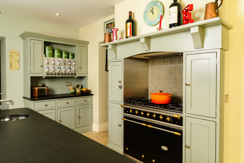 Inspiration for a country kitchen in Other with an undermount sink, shaker cabinets, green cabinets, brown splashback, subway tile splashback, black appliances and with island.