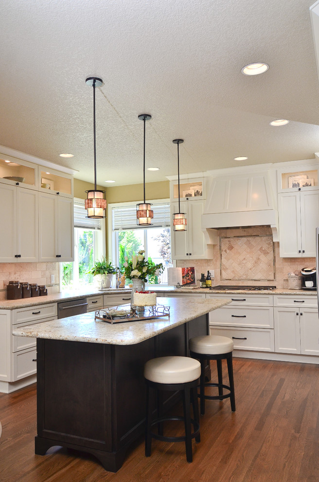 Inspiration for a mid-sized transitional u-shaped kitchen in Portland with an undermount sink, shaker cabinets, white cabinets, granite benchtops, beige splashback, stainless steel appliances, medium hardwood floors and with island.