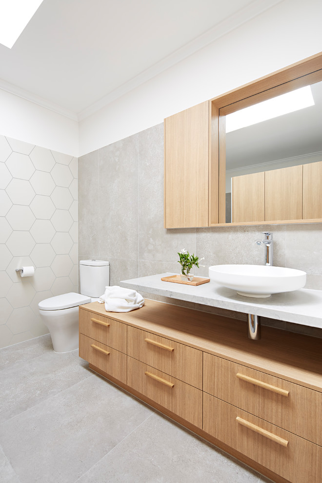 Design ideas for a mid-sized beach style master bathroom in Melbourne with beaded inset cabinets, light wood cabinets, an alcove shower, a wall-mount toilet, multi-coloured tile, stone slab, multi-coloured walls, a vessel sink, marble benchtops, an open shower and white benchtops.
