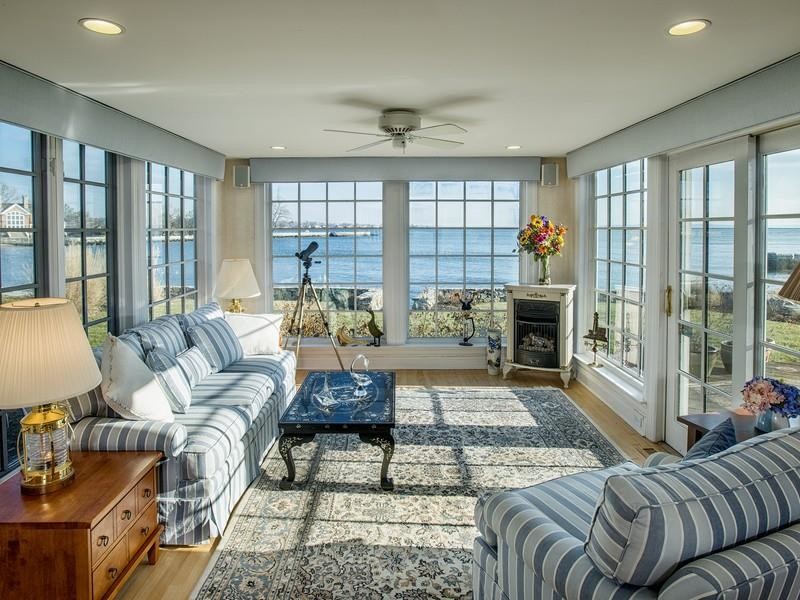 This is an example of a beach style sunroom in New York.