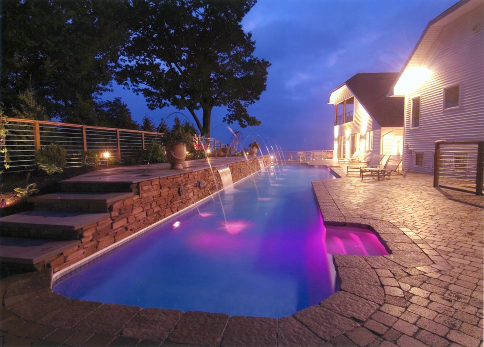 Large transitional backyard stone and rectangular lap pool fountain photo in Baltimore