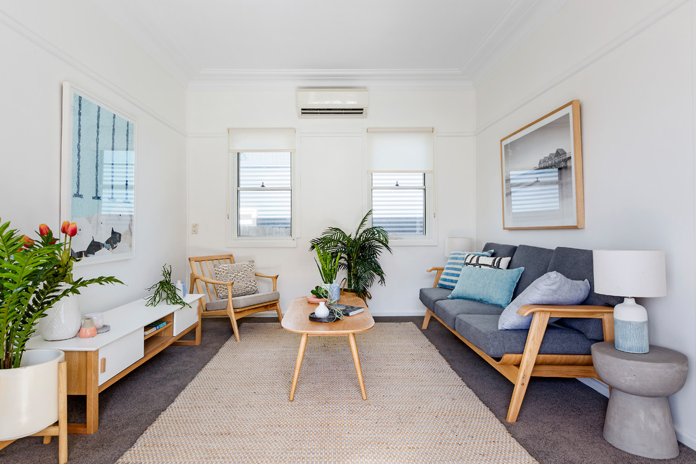 Mid-sized scandinavian formal enclosed living room in Sydney with white walls, carpet and brown floor.