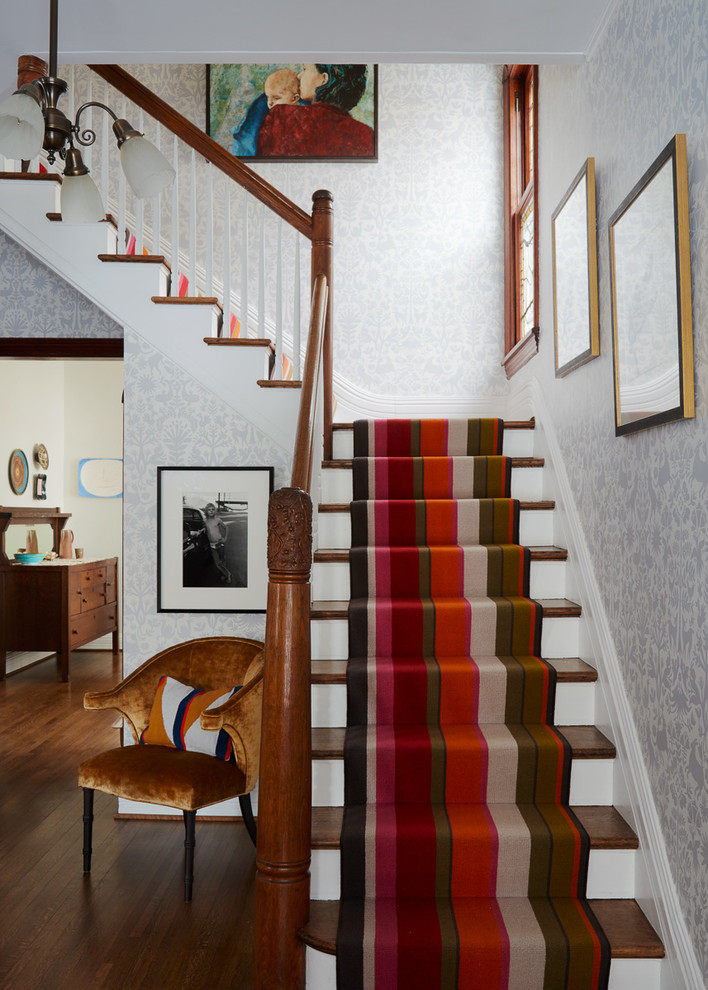 This is an example of a mid-sized traditional wood l-shaped staircase in Chicago.