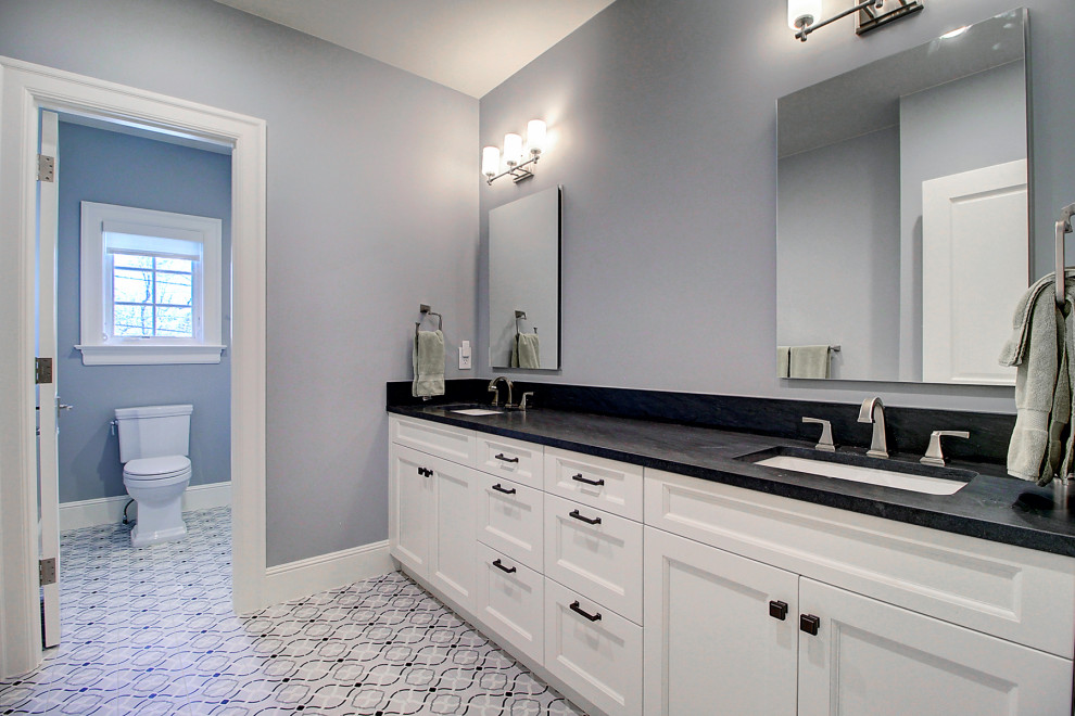 Huge transitional kids' gray tile and subway tile ceramic tile, white floor and double-sink bathroom photo in Denver with recessed-panel cabinets, white cabinets, a one-piece toilet, white walls, an undermount sink, onyx countertops, black countertops and a built-in vanity