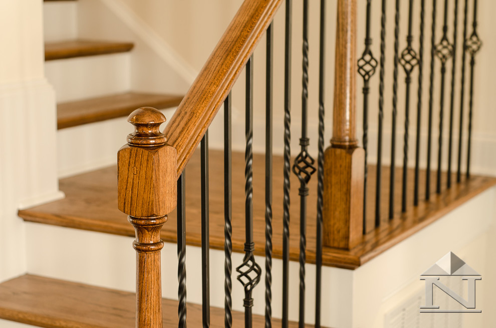 This is an example of a large arts and crafts wood l-shaped staircase in Charlotte with wood risers.