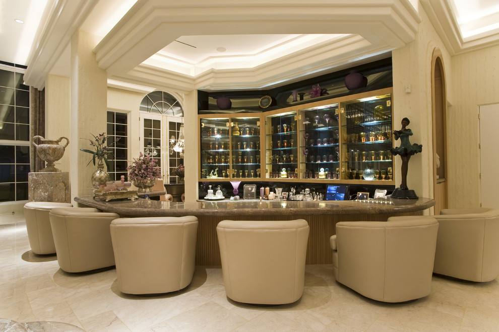 This is an example of an expansive traditional seated home bar in Other with glass-front cabinets.
