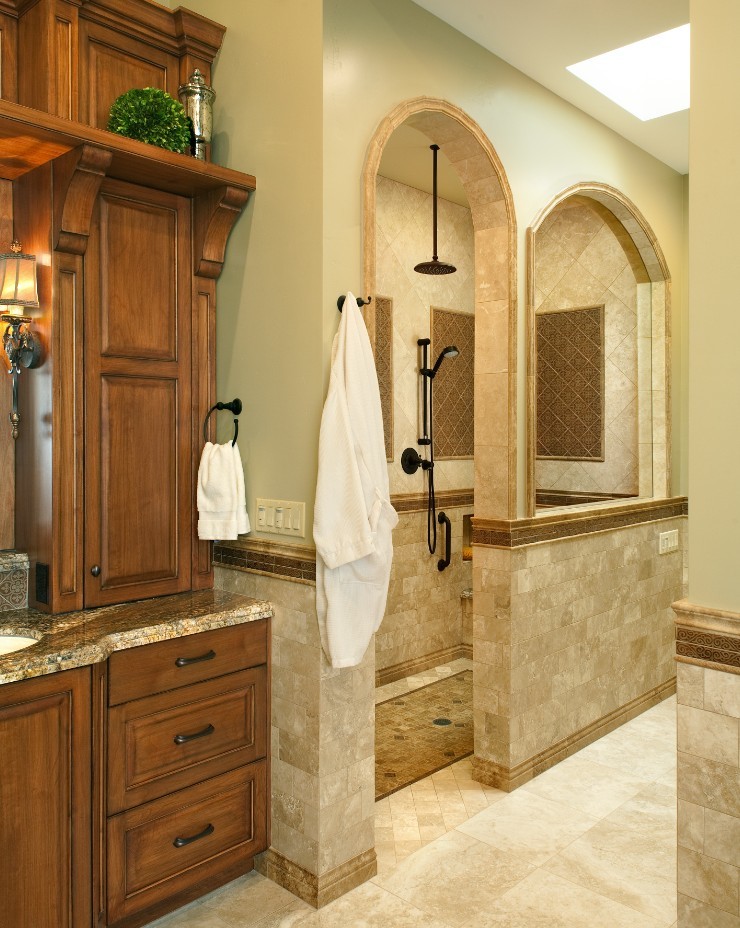 Inspiration for an expansive traditional bathroom in San Diego with an undermount sink, medium wood cabinets, granite benchtops, a curbless shower and beige tile.