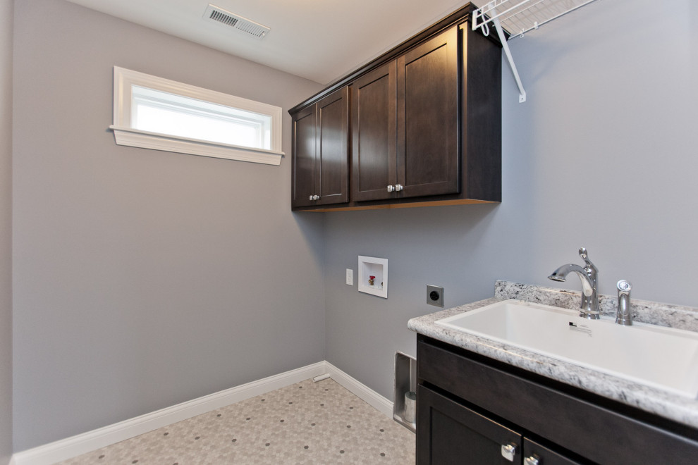 Transitional utility room photo in Cedar Rapids with gray walls