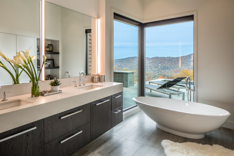 This is an example of a mid-sized contemporary master bathroom in Other with flat-panel cabinets, dark wood cabinets, a freestanding tub, a curbless shower, white walls, an undermount sink, engineered quartz benchtops, grey floor, white benchtops, a single vanity and a floating vanity.