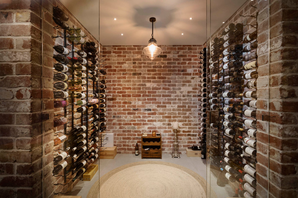 Photo of a transitional wine cellar in Perth with display racks and grey floor.
