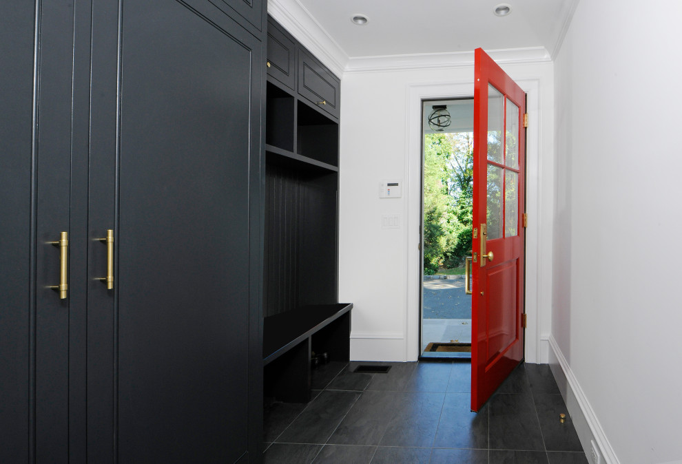 Small contemporary mudroom in New York with white walls, ceramic floors and black floor.