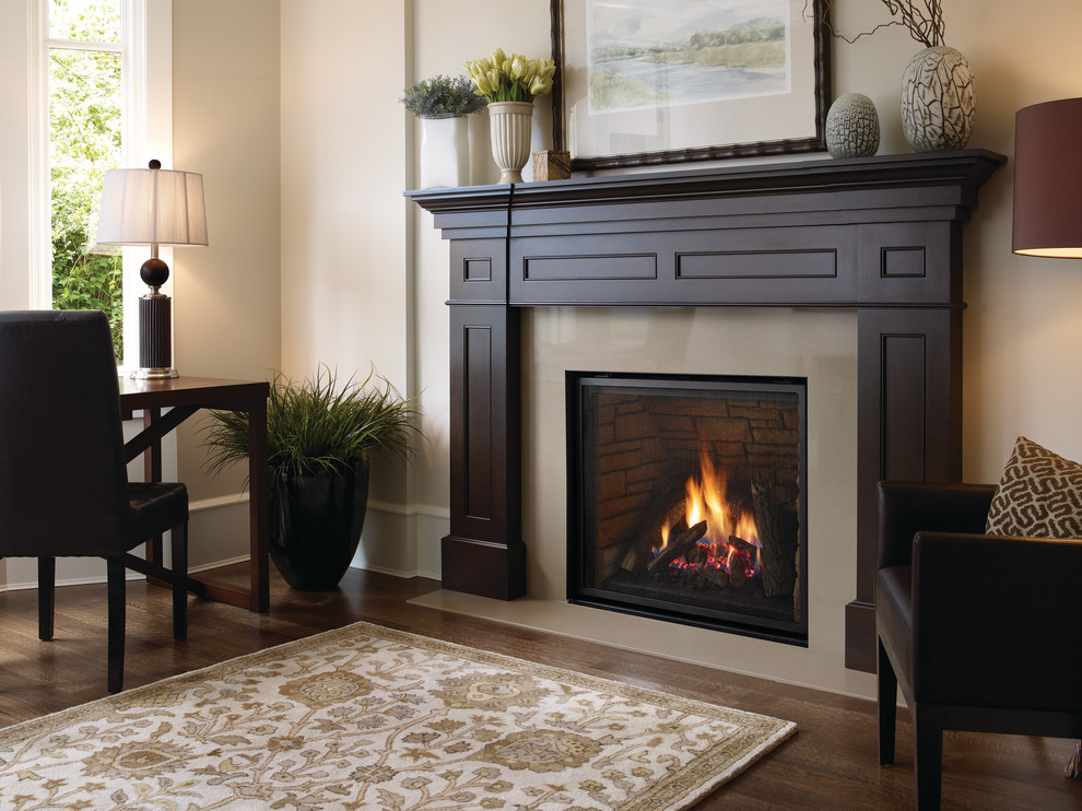 Design ideas for a large traditional family room in Seattle with beige walls, dark hardwood floors, a standard fireplace, a tile fireplace surround and brown floor.