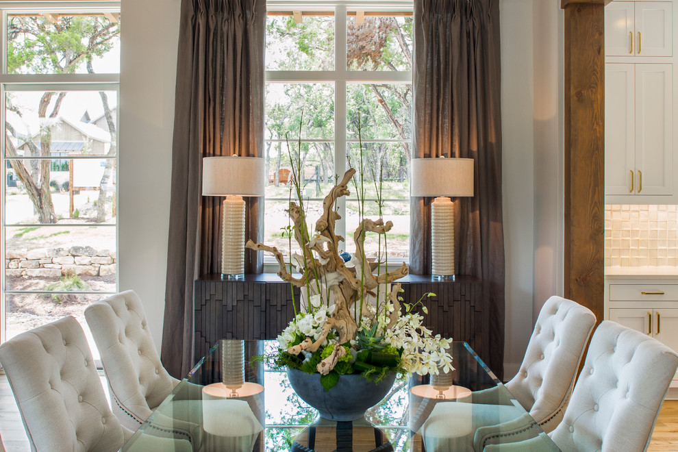Example of a transitional light wood floor dining room design in Austin with white walls