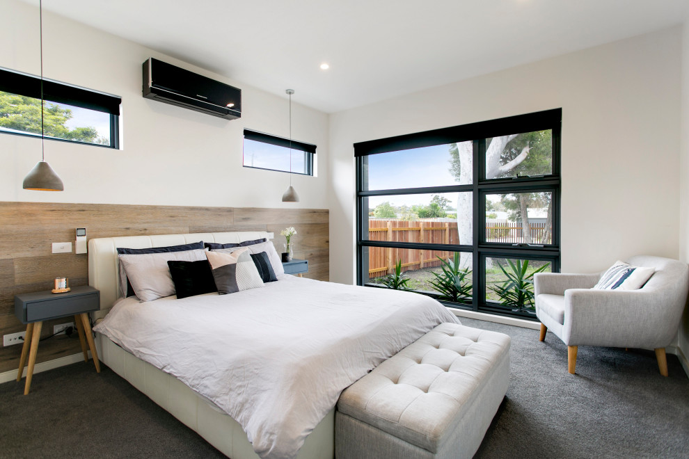 Photo of a contemporary guest bedroom in Melbourne with white walls, carpet, no fireplace and grey floor.