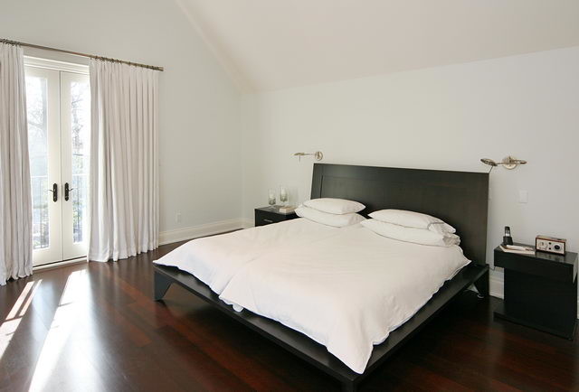 Bedroom - large transitional master medium tone wood floor bedroom idea in Toronto with white walls and no fireplace