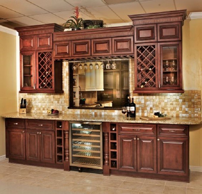 Photo of a small single-wall home bar in Other with raised-panel cabinets, red cabinets, granite benchtops, mosaic tile splashback and multi-coloured benchtop.