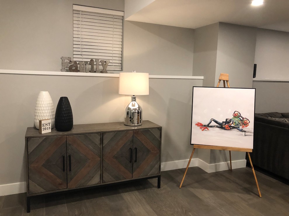 Photo of a mid-sized transitional open concept family room in New York with a home bar, grey walls, medium hardwood floors, no fireplace and grey floor.