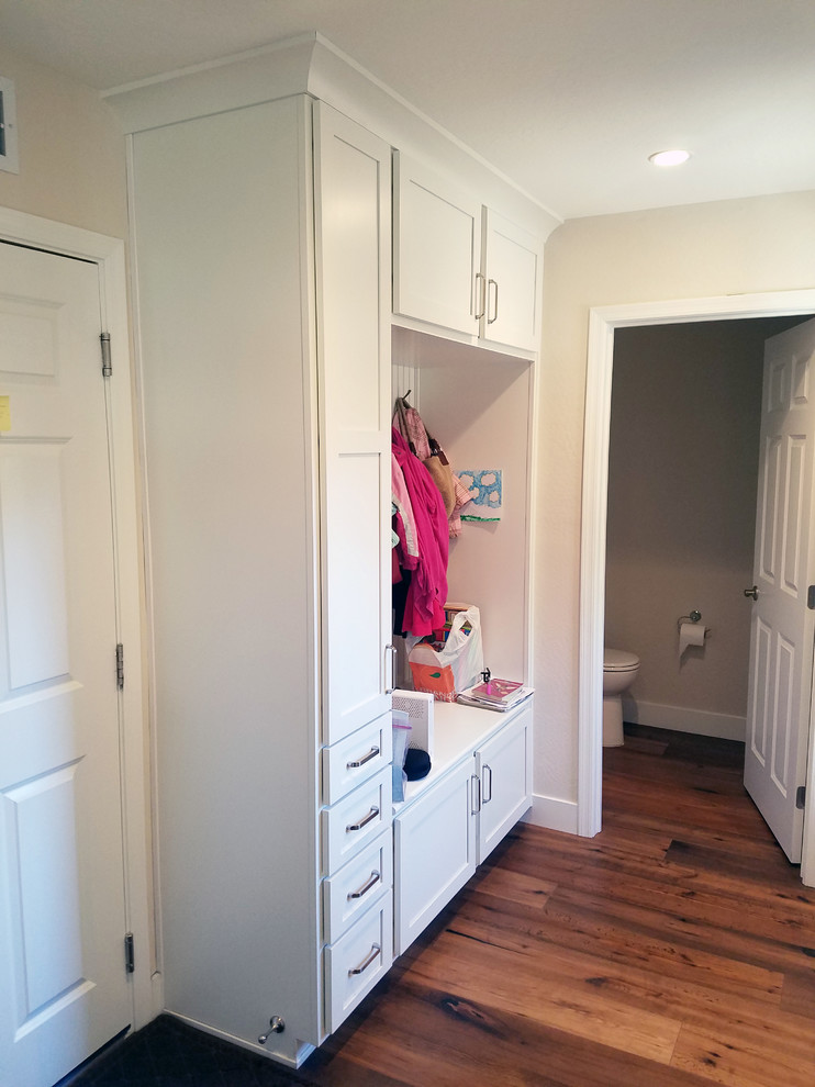 Example of a mid-sized transitional medium tone wood floor mudroom design in Phoenix with beige walls