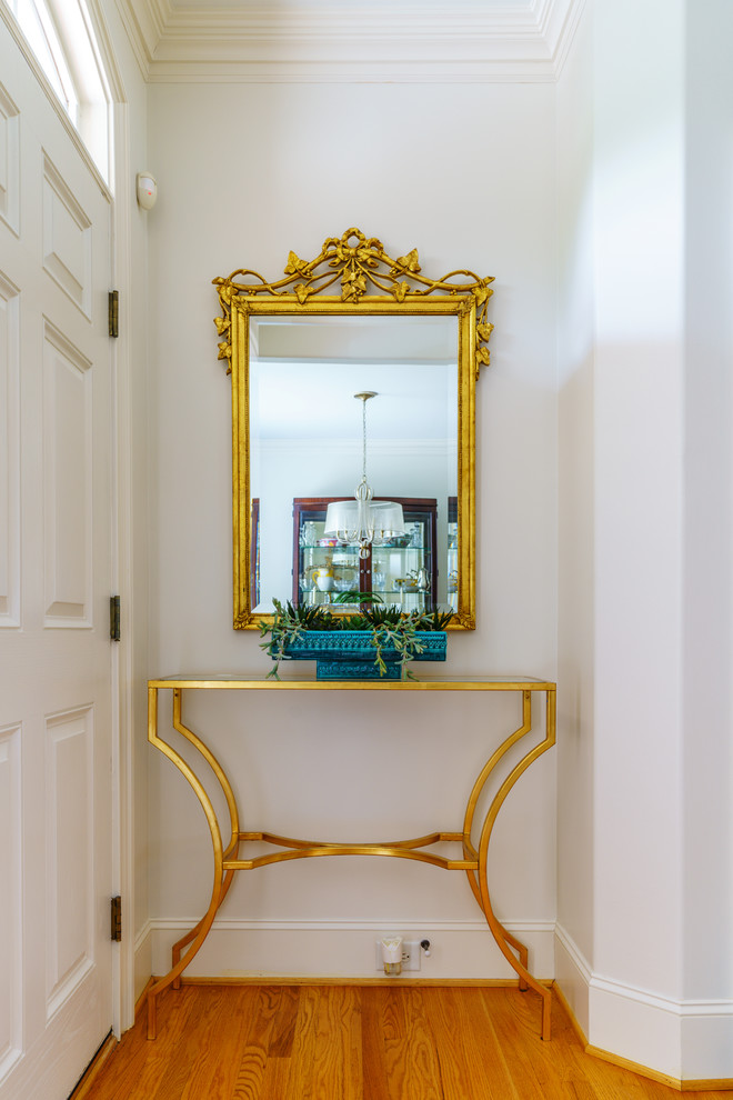 Front door - mid-sized transitional medium tone wood floor and brown floor front door idea with white walls and a white front door