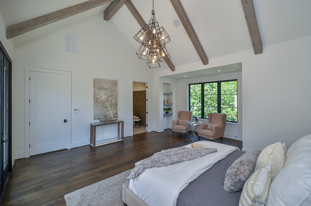 Inspiration for a large transitional master bedroom in Houston with white walls, medium hardwood floors and brown floor.