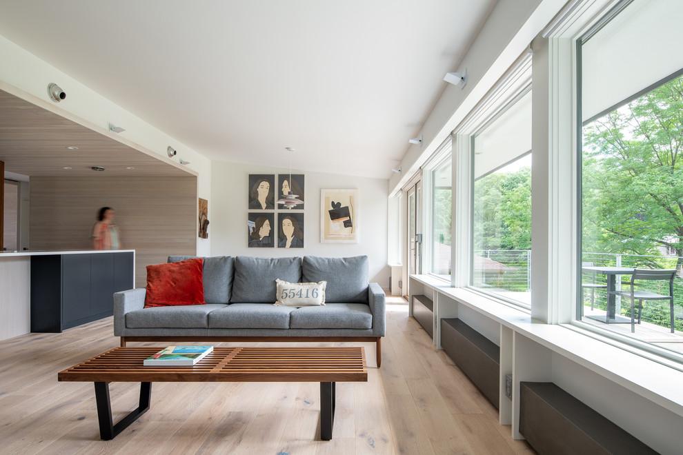 Living room - mid-century modern open concept light wood floor and beige floor living room idea in Minneapolis with white walls and no fireplace
