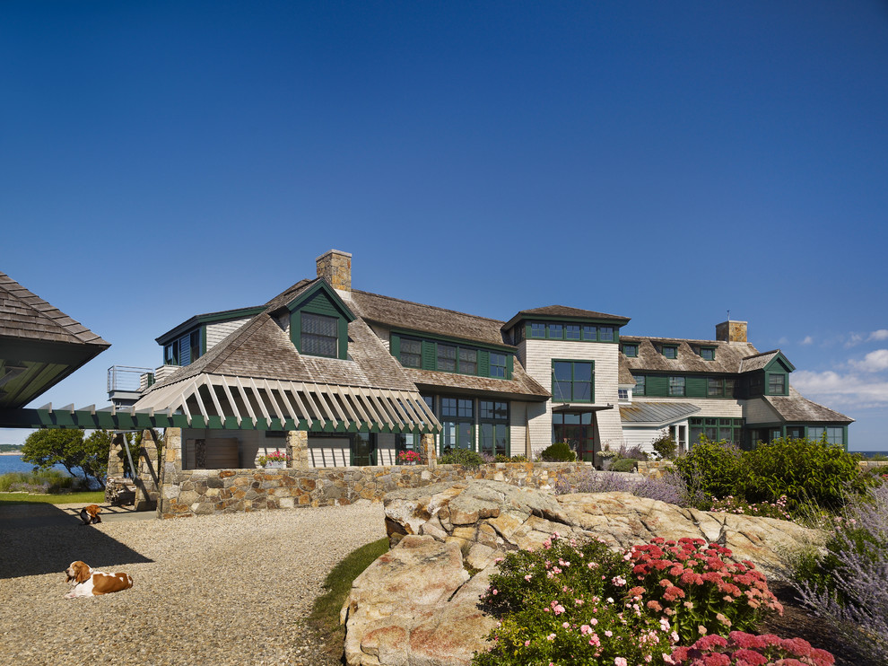Photo of a beach style exterior in Boston with stone veneer.