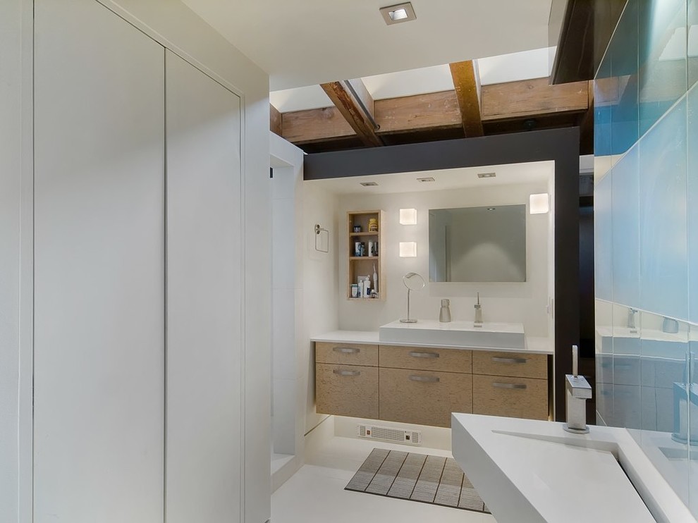 Design ideas for an industrial bathroom in Denver with a wall-mount sink, flat-panel cabinets, light wood cabinets and white walls.
