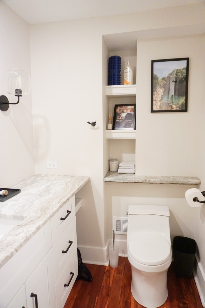 Huge transitional light wood floor and brown floor eat-in kitchen photo with an undermount sink, shaker cabinets, white cabinets, granite countertops, white backsplash, ceramic backsplash, stainless steel appliances, an island and white countertops
