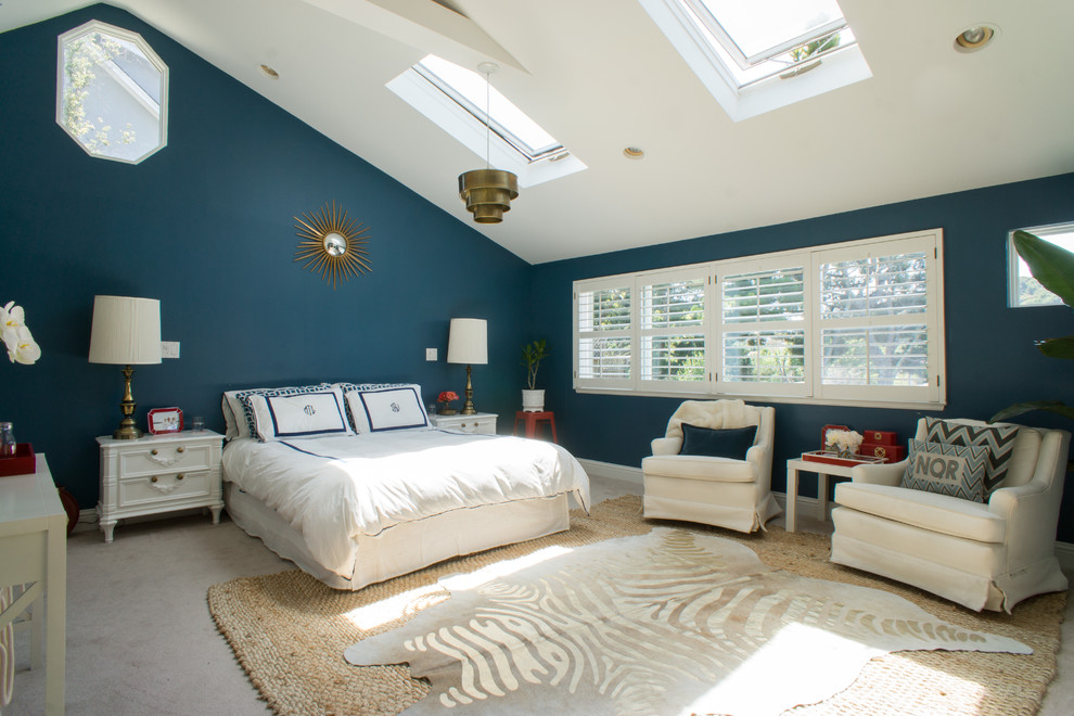 This is an example of a transitional master bedroom in San Francisco with blue walls, carpet and no fireplace.