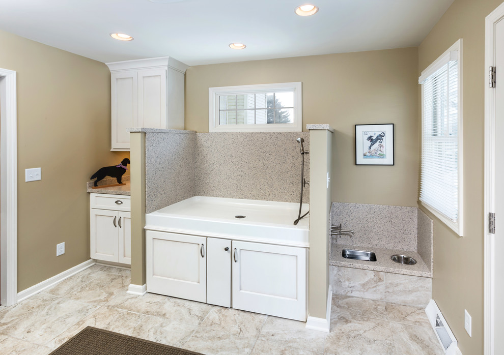 This is an example of a large transitional utility room in Milwaukee with recessed-panel cabinets, white cabinets, quartz benchtops, beige walls and ceramic floors.