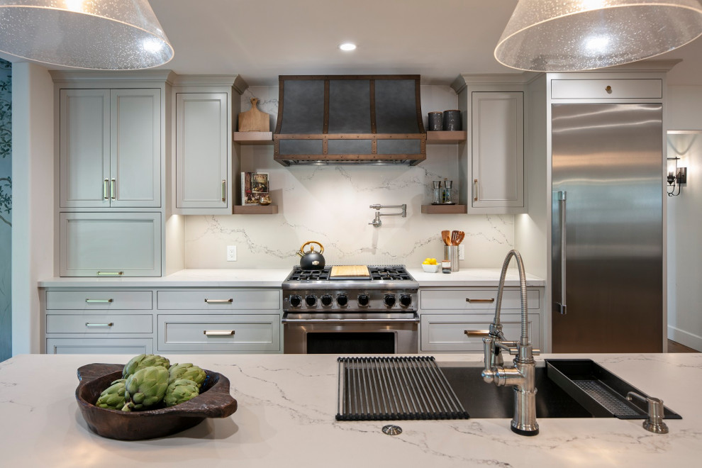Inspiration for a huge transitional l-shaped medium tone wood floor and brown floor open concept kitchen remodel with an undermount sink, shaker cabinets, gray cabinets, quartz countertops, white backsplash, quartz backsplash, stainless steel appliances, an island and white countertops