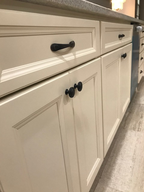 Inspiration for a mid-sized transitional galley porcelain tile and beige floor eat-in kitchen remodel with an undermount sink, flat-panel cabinets, beige cabinets, granite countertops, multicolored backsplash, mosaic tile backsplash, stainless steel appliances, a peninsula and white countertops