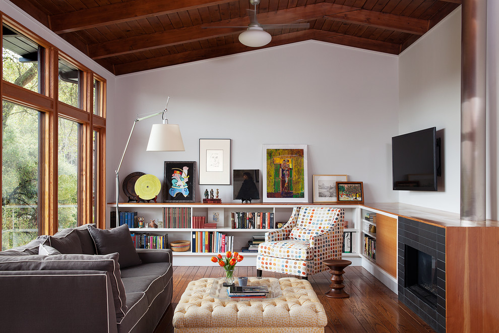 Small mid-century modern family room photo in San Francisco with a standard fireplace, a tile fireplace and white walls