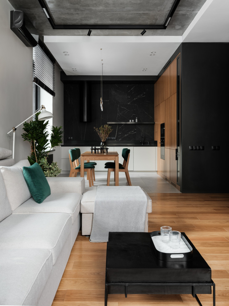 Photo of a large contemporary open plan living room in Saint Petersburg with a music area, black walls, medium hardwood flooring, a wall mounted tv, brown floors and panelled walls.