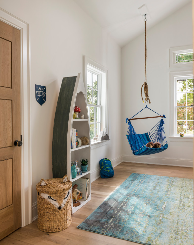 Inspiration for a large transitional gender-neutral kids' playroom for kids 4-10 years old in Other with white walls, medium hardwood floors and beige floor.