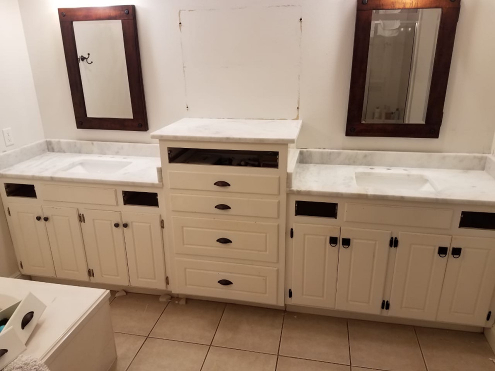 Medium sized ensuite bathroom in Other with white worktops, double sinks and a built in vanity unit.